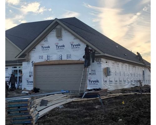 Home addition under construction with house wrap